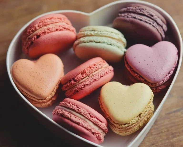 Heart-shaped macarons in various flavors and colors, perfect for special occasions.